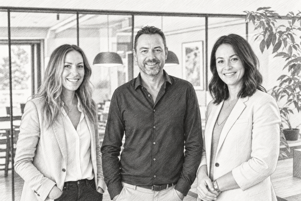Three adults standing together indoors.